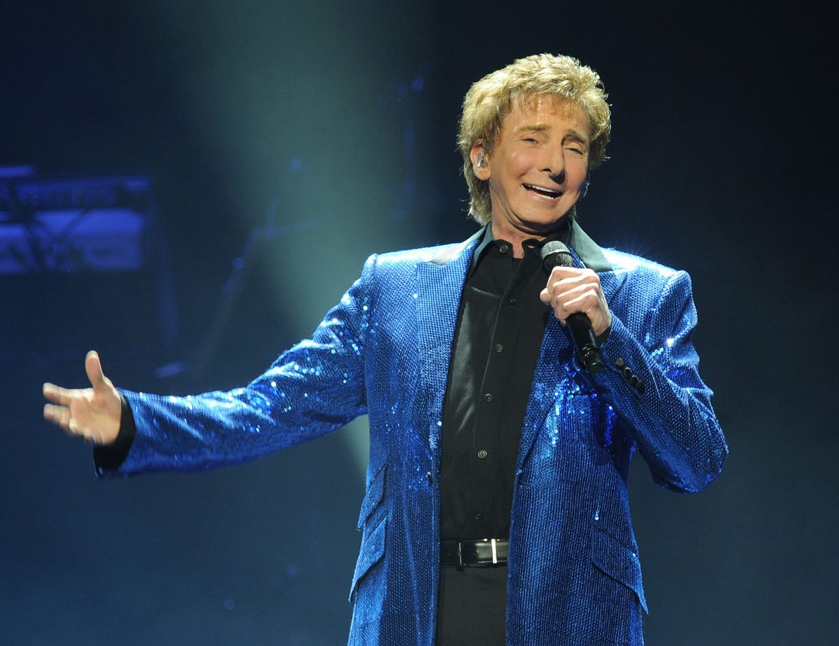 Barry Manilow cantando con un saco azul